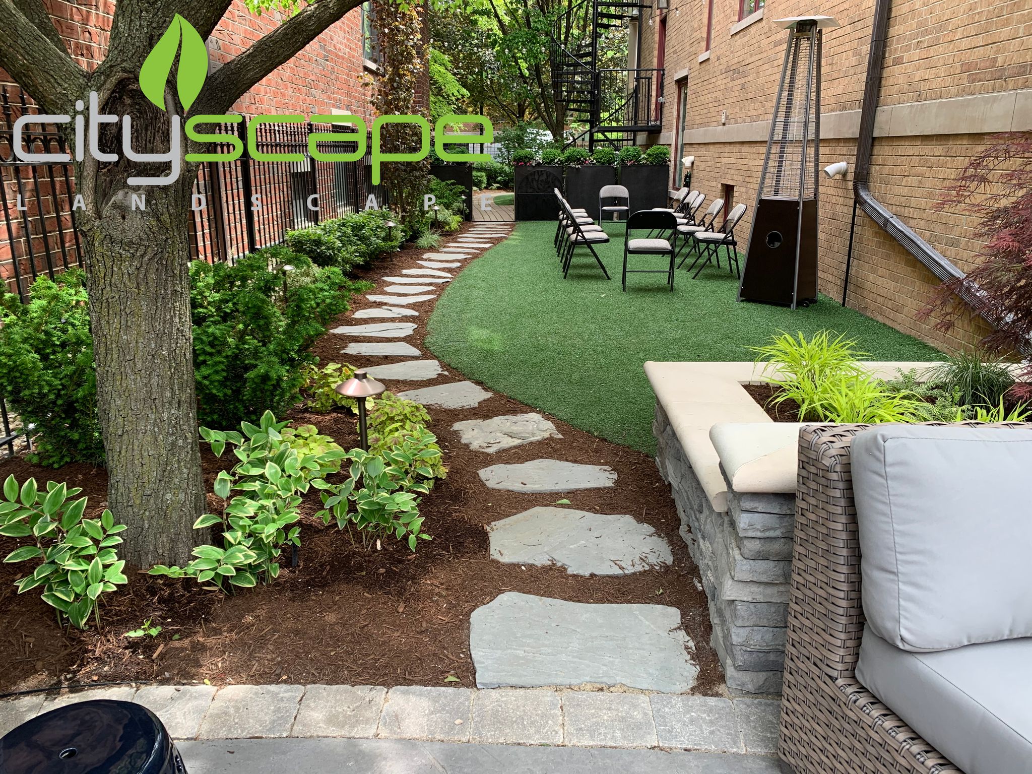 A garden with a stone path and seating area