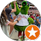 A woman in a green costume standing next to a mascot